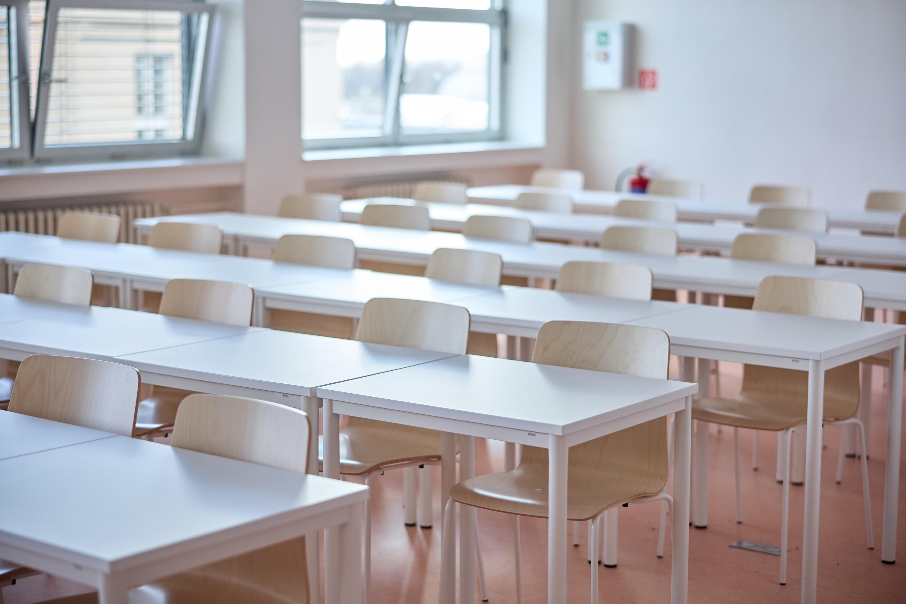 A bright classroom with rows of desks and chairs